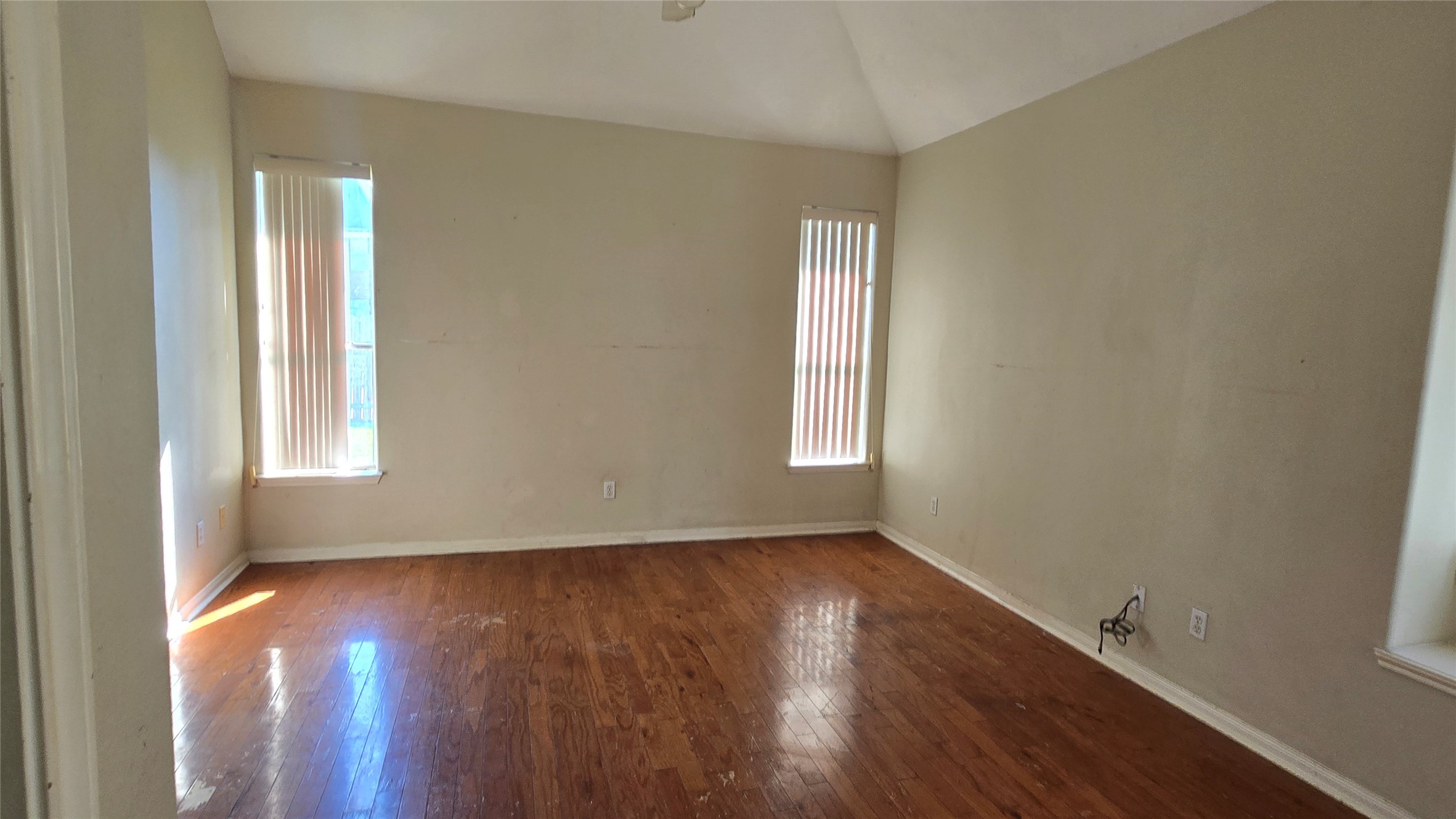 131 Annes Way Stafford, TX 77477 - Photo 11 of 25 an empty room with wooden floor and windows