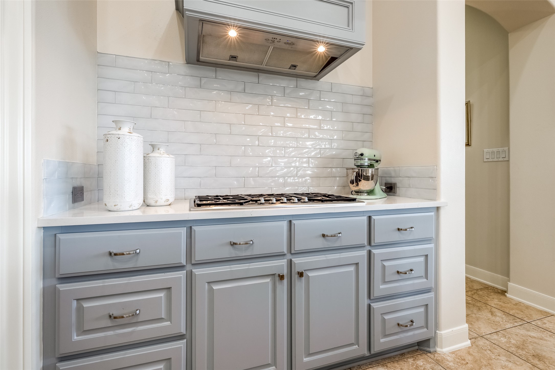31102 Lower Oxbow Trace Fulshear, TX 77441 - Photo 13 of 50 Recently remodeled gorgeous Chef's Kitchen with light blue cabinets, beautiful tiled back splash, 5 gas burner 2025, with industrial overhead vent, quartz counters