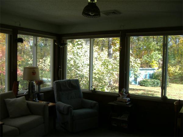 61 Hollis Road Lunenburg, MA 01462 - Photo 11 of 27 a living room with furniture and a floor to ceiling window