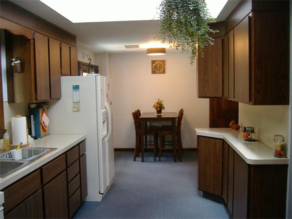 61 Hollis Road Lunenburg, MA 01462 - Photo 7 of 27 a room with a table chairs and a refrigerator