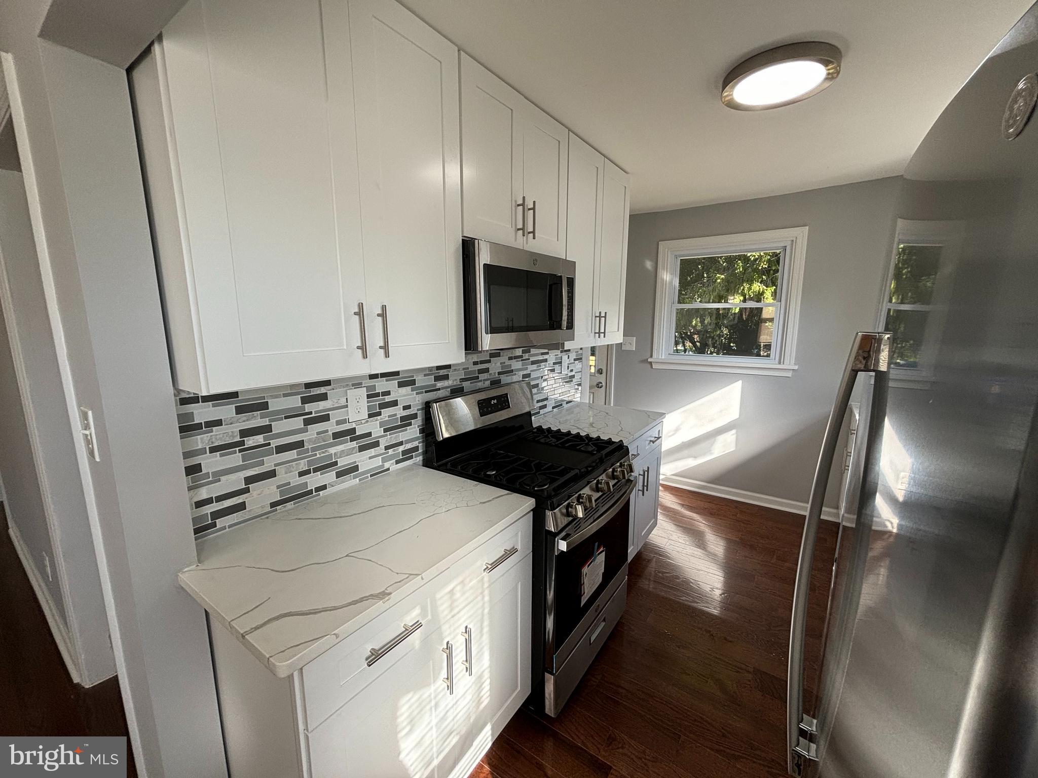 2507 Mason Street Silver Spring, MD 20902 - Photo 11 of 49 a kitchen with granite countertop a stove and a refrigerator