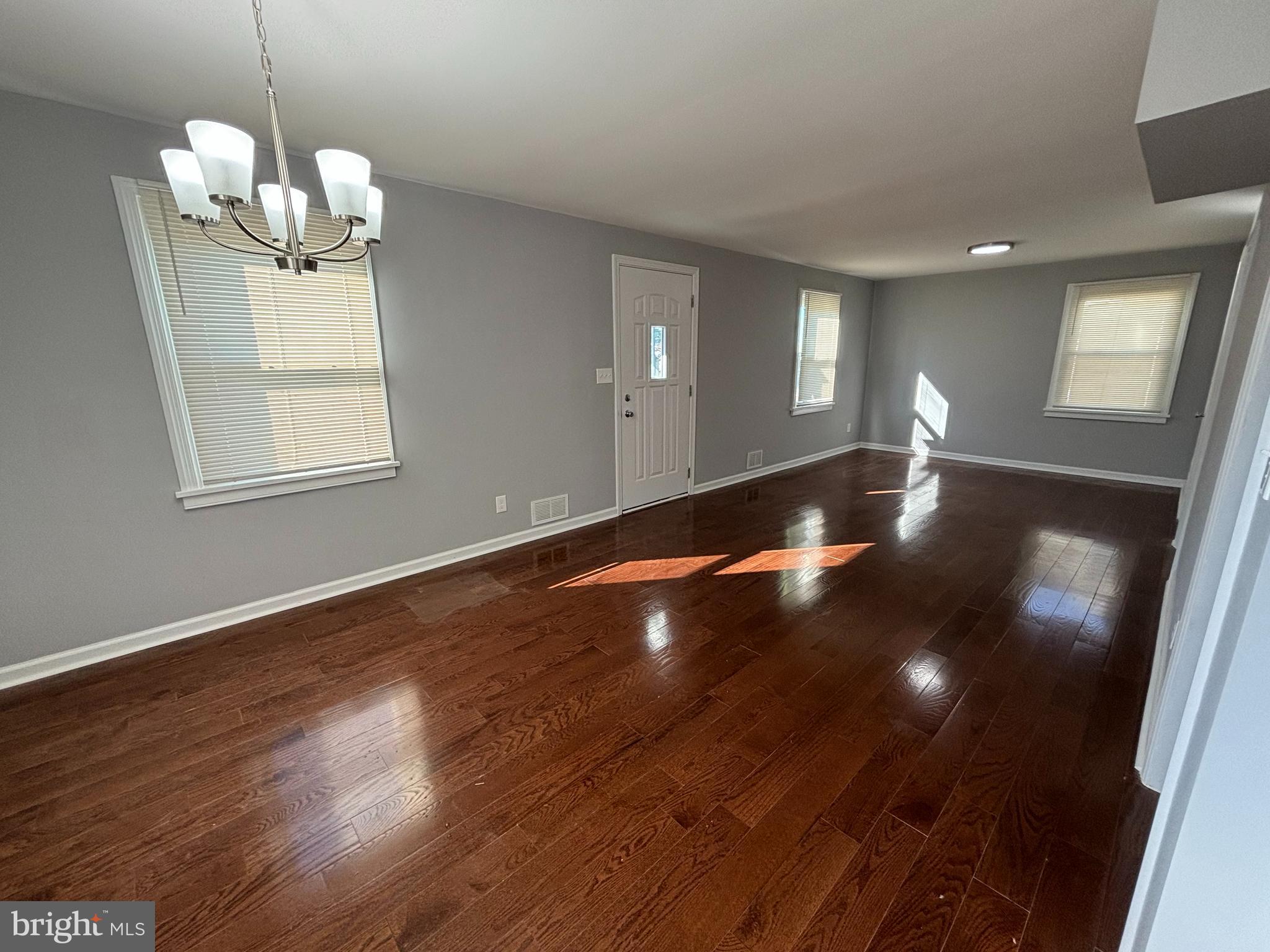 2507 Mason Street Silver Spring, MD 20902 - Photo 9 of 49 a view of an empty room with wooden floor and a chandelier