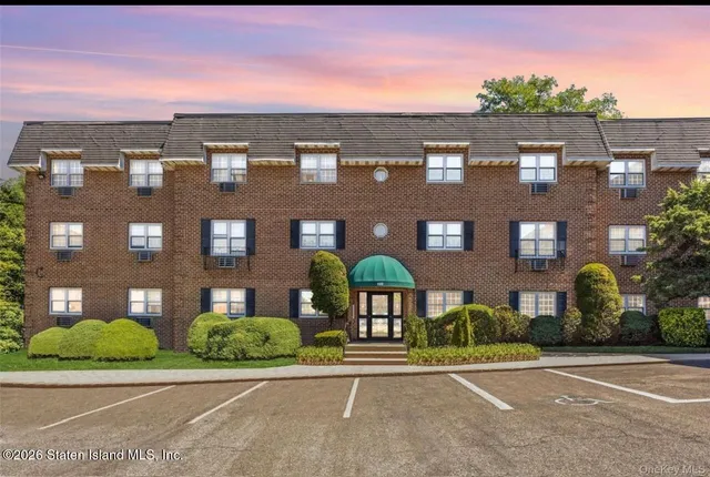 a view of a brick building next to a yard