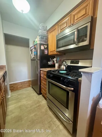 a kitchen with stainless steel appliances granite countertop a stove and a microwave