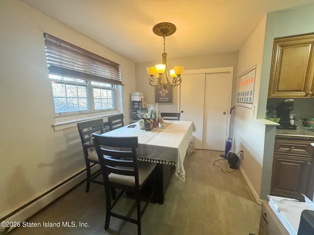 a view of a dining room with furniture and window