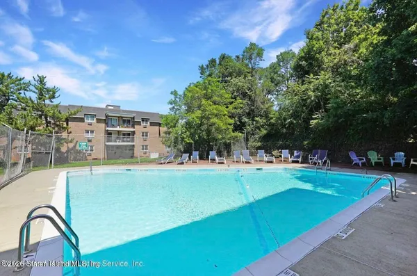 a view of a swimming pool with a yard