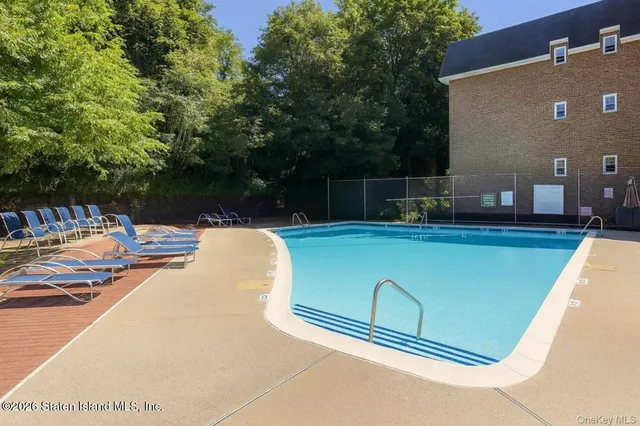 a view of swimming pool with a lounge chair