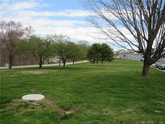 a view of grassy field with benches