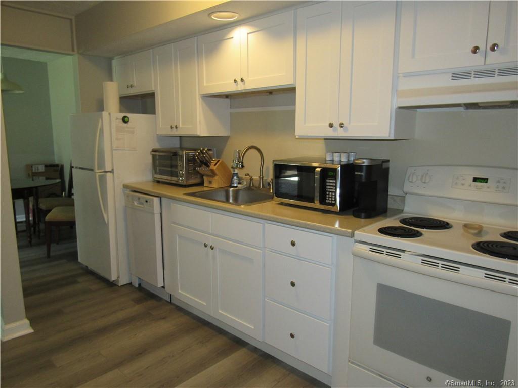 83 Horse Pond Road, Unit B Salem, CT 06420 - Photo 6 of 13 a kitchen with white cabinets and white appliances