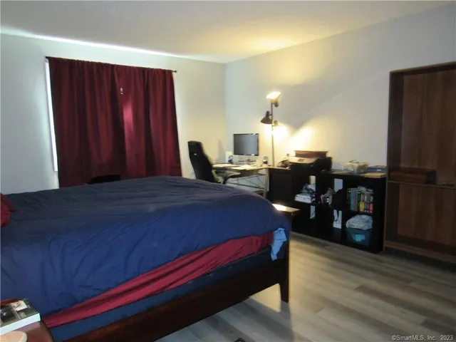 a bed sitting in a room next to a window