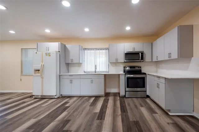 a kitchen with stove cabinets and refrigerator