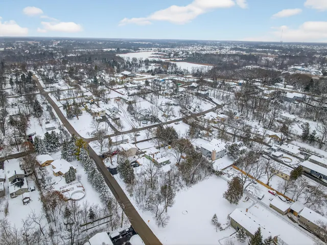an aerial view of residential houses with city view