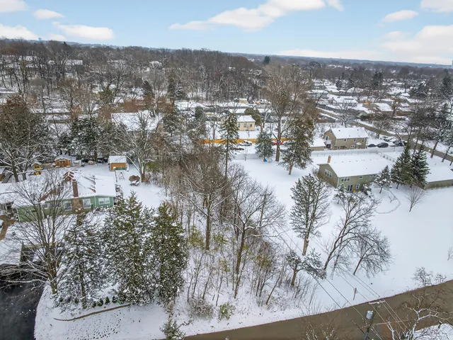 an aerial view of residential building with trees