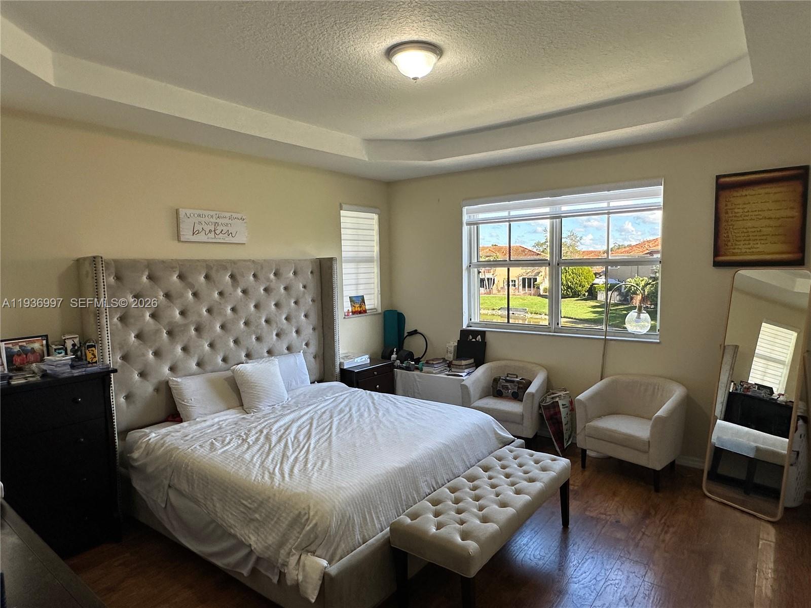 15313 Southwest 31st Terrace, Unit 15313 Miami, FL 33185 - Photo 11 of 21 a bedroom with a bed couch and a window