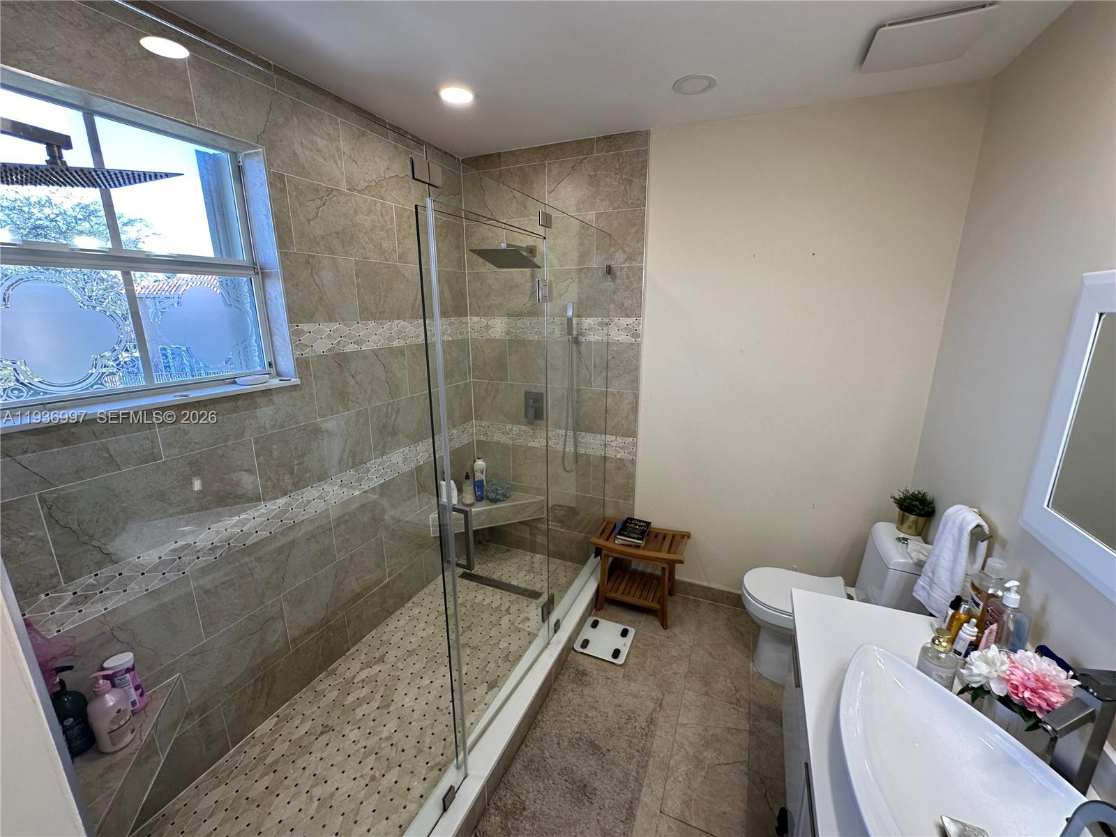 15313 Southwest 31st Terrace, Unit 15313 Miami, FL 33185 - Photo 12 of 21 a bathroom with a sink mirror toilet and bathtub