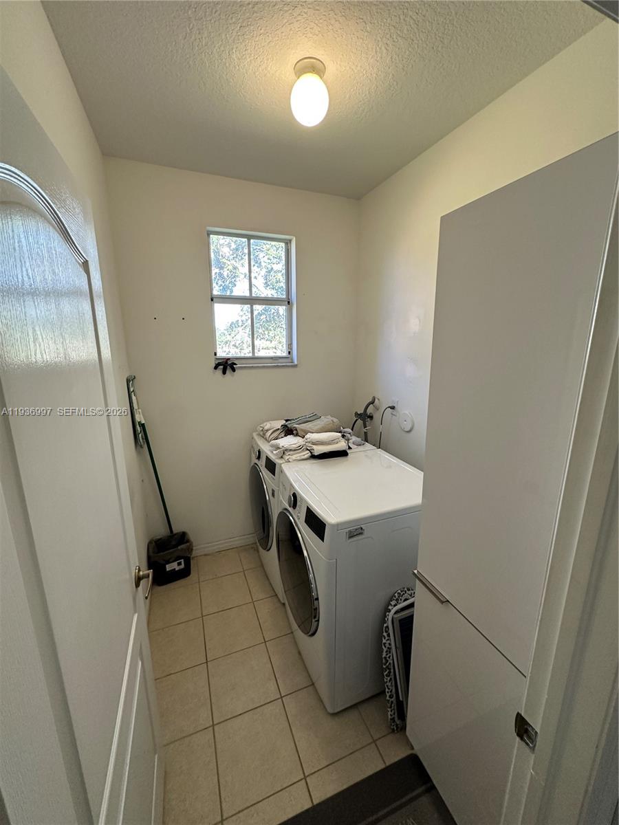 15313 Southwest 31st Terrace, Unit 15313 Miami, FL 33185 - Photo 16 of 21 a utility room with dryer and washer