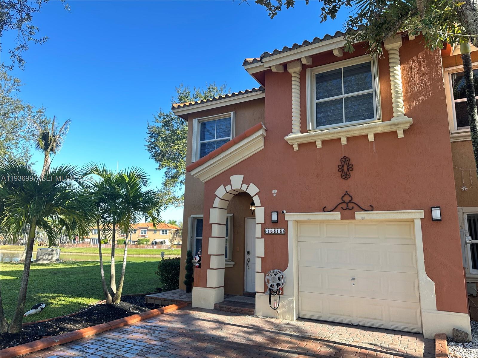 15313 Southwest 31st Terrace, Unit 15313 Miami, FL 33185 - Photo 2 of 21 a view of a house with a yard