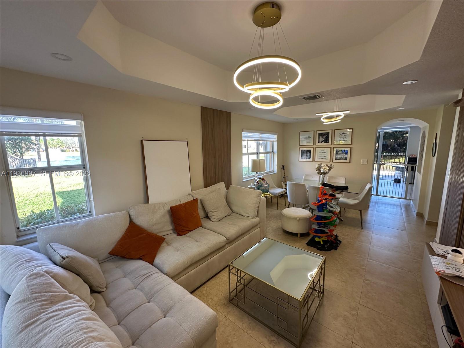 15313 Southwest 31st Terrace, Unit 15313 Miami, FL 33185 - Photo 5 of 21 a living room with furniture and a large window