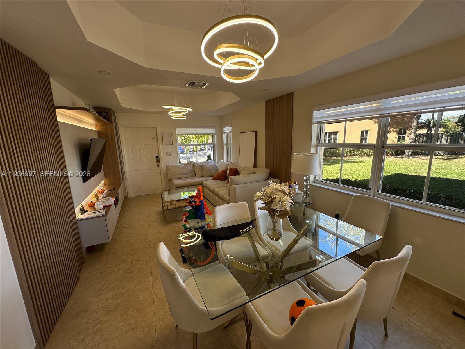 15313 Southwest 31st Terrace, Unit 15313 Miami, FL 33185 - Photo 7 of 21 a living room with furniture and a flat screen tv