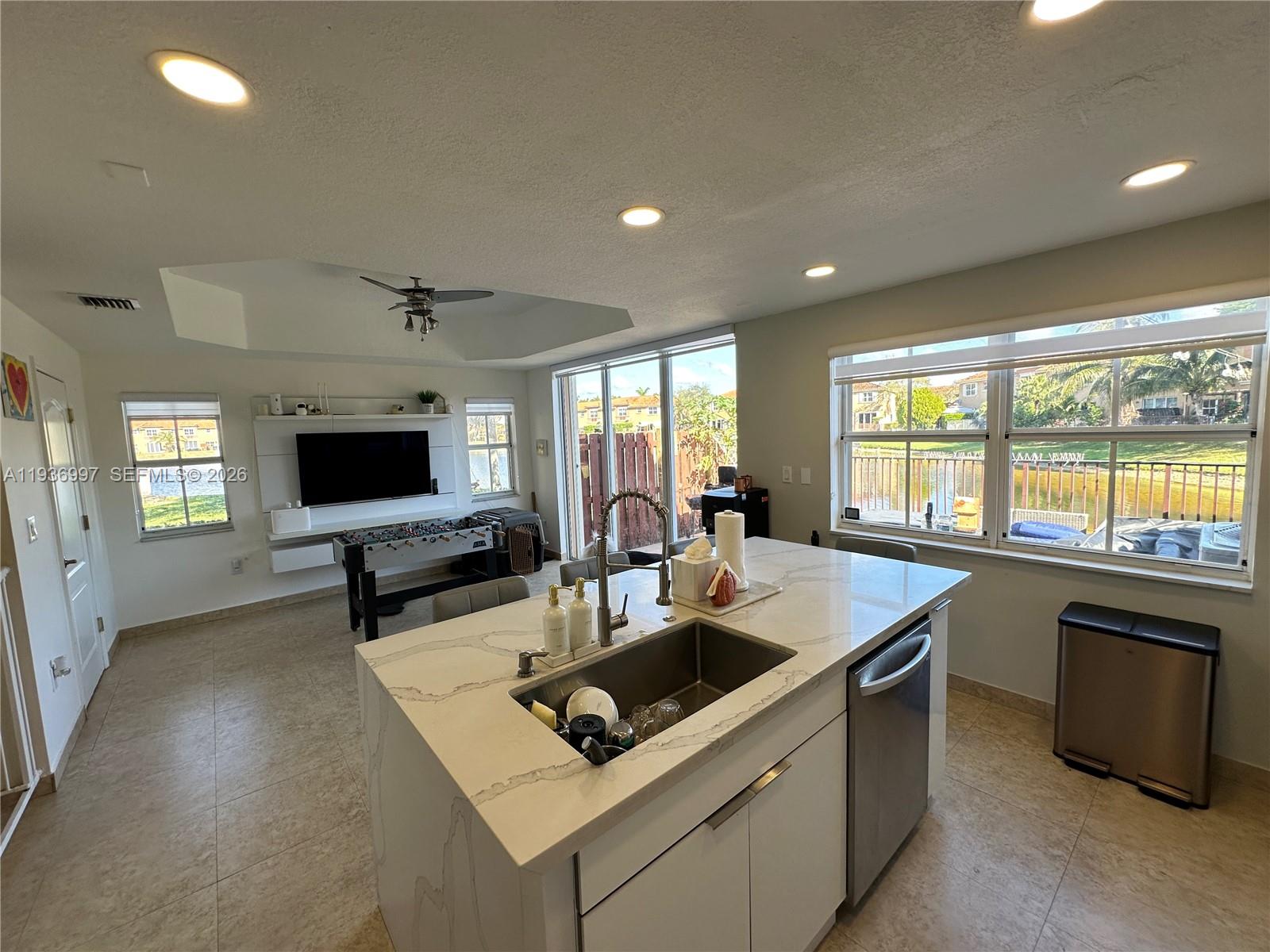 15313 Southwest 31st Terrace, Unit 15313 Miami, FL 33185 - Photo 9 of 21 a kitchen that has a sink and a stove in it