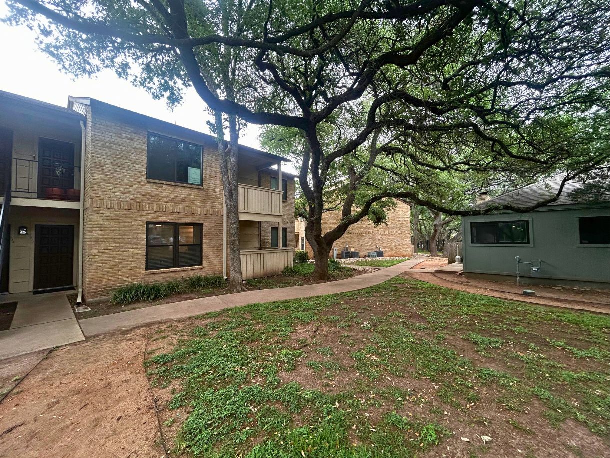 8210 Bent Tree Road, Unit 247 Austin, TX 78759 - Photo 16 of 21 a house that has a tree in front of it