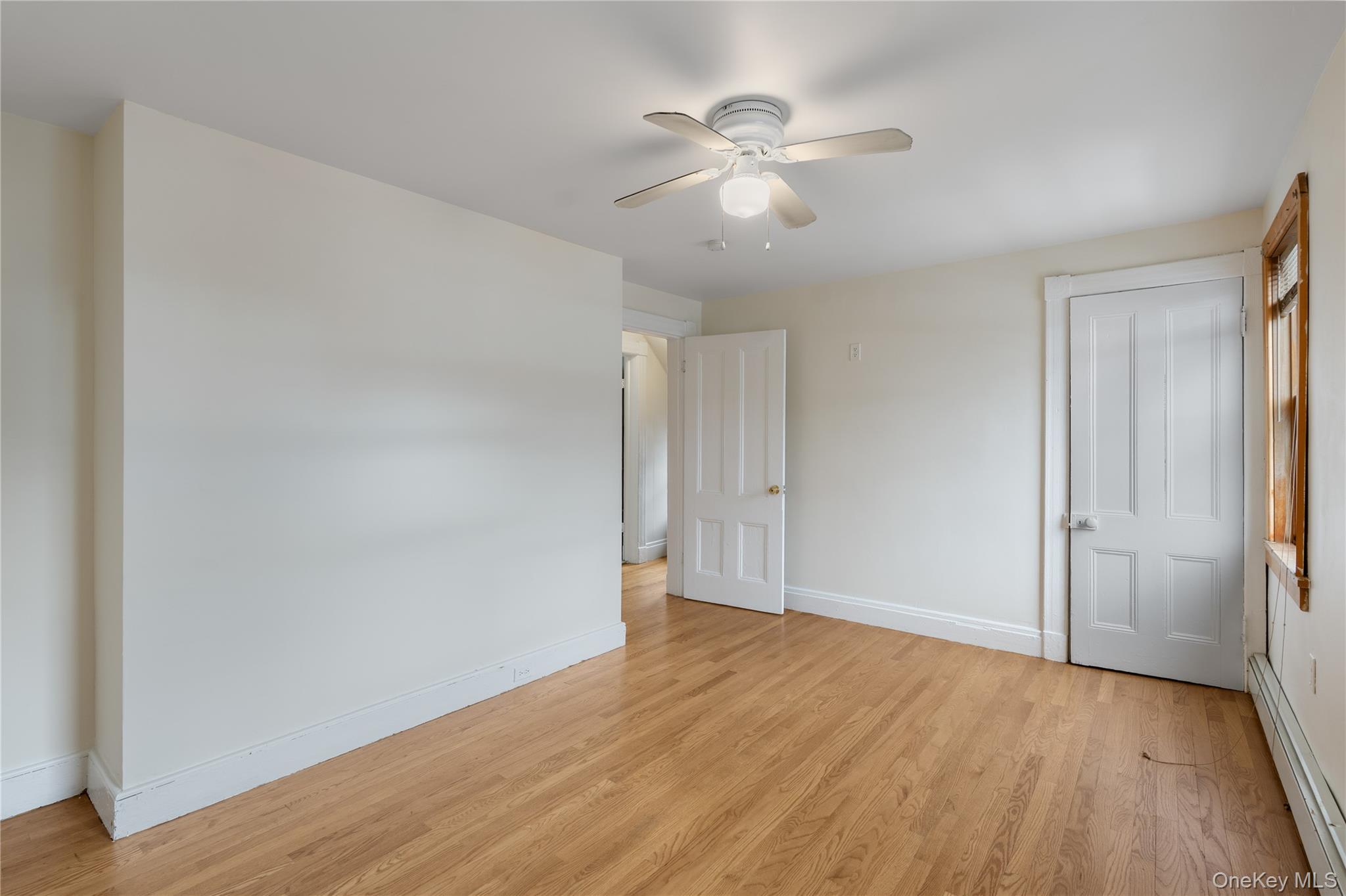 Undisclosed Address Middletown, NY 10940 - Photo 15 of 24 a view of an empty room with wooden floor
