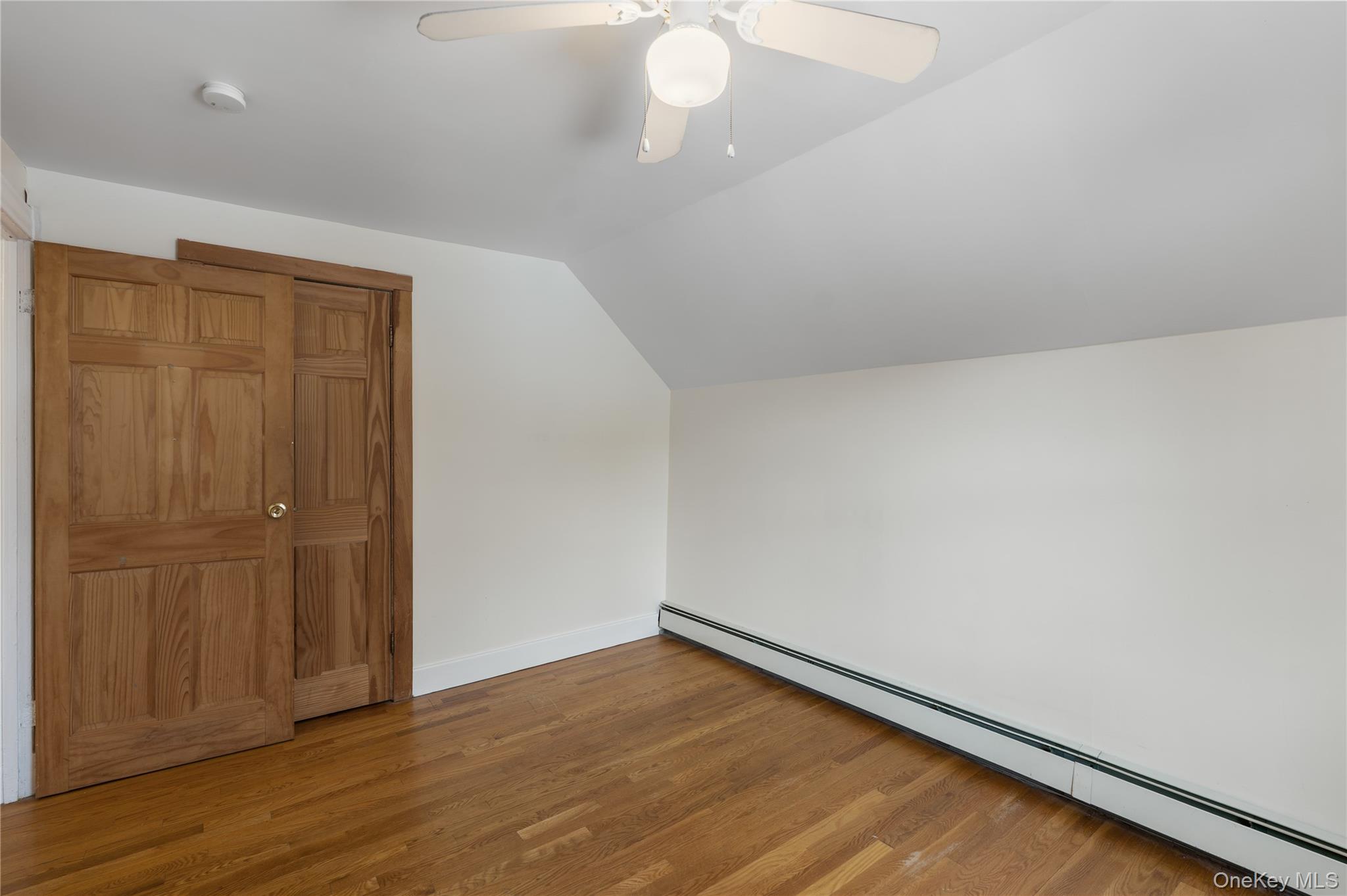 Undisclosed Address Middletown, NY 10940 - Photo 17 of 24 an empty room with wooden floor closet and windows