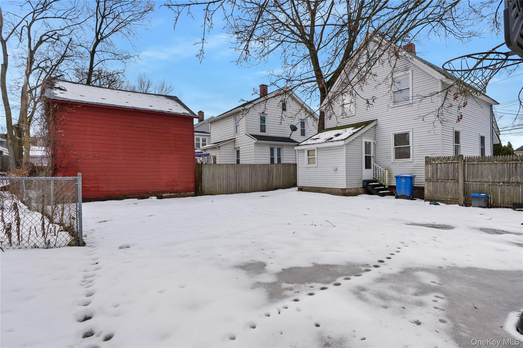 Undisclosed Address Middletown, NY 10940 - Photo 22 of 24 a view of a house with a yard covered in snow