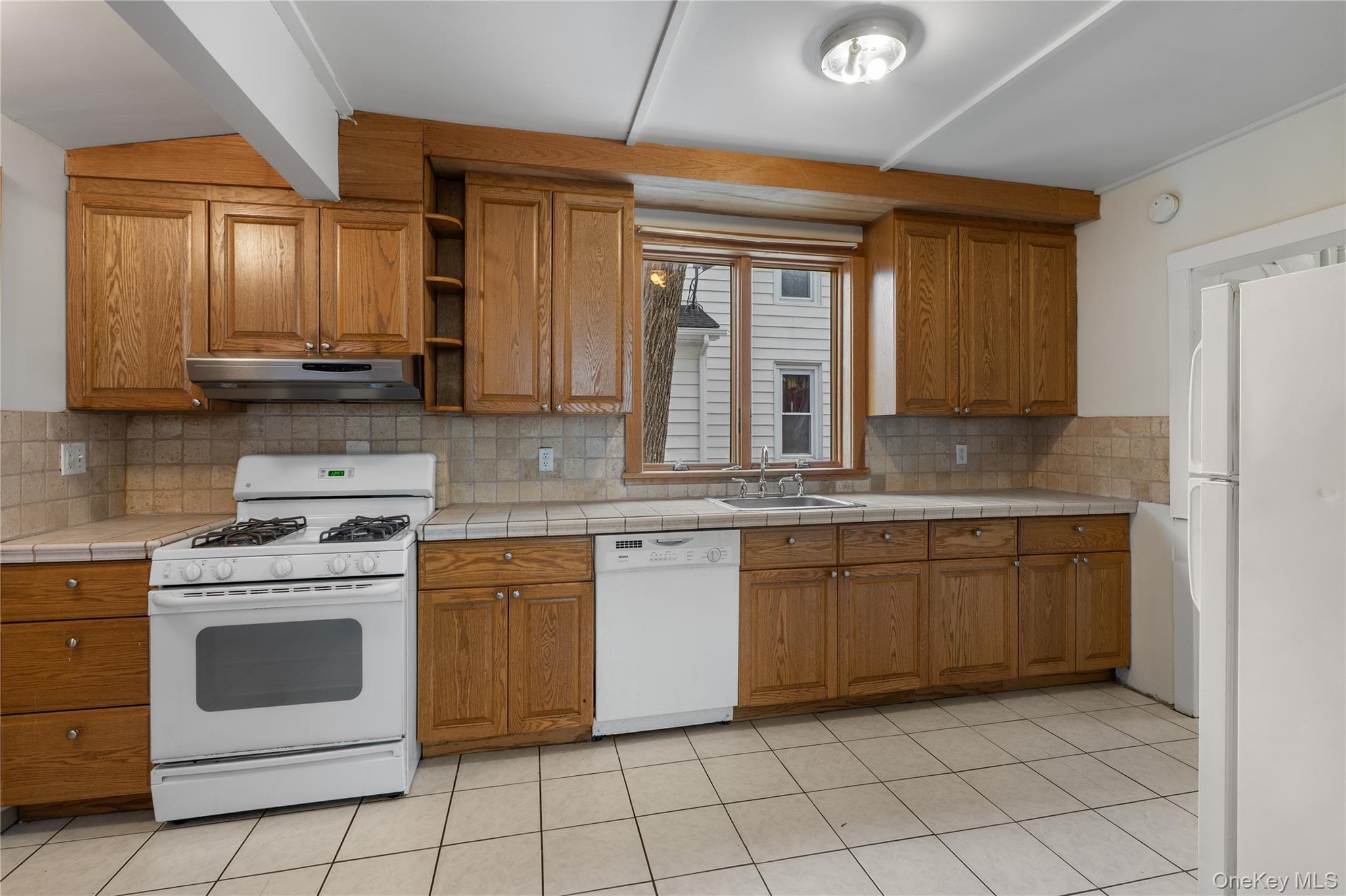 Undisclosed Address Middletown, NY 10940 - Photo 9 of 24 a kitchen with a stove sink and cabinets