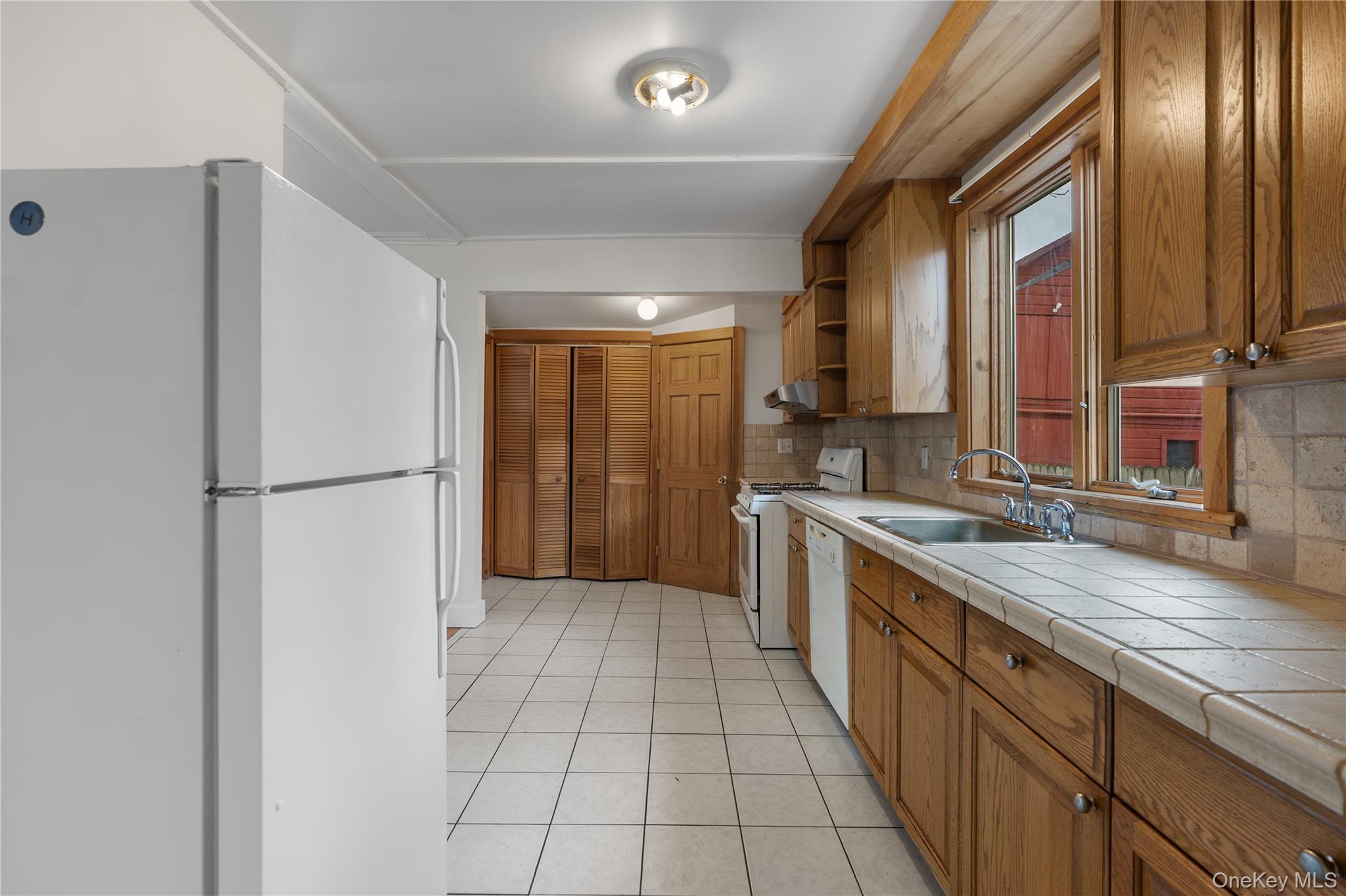 Undisclosed Address Middletown, NY 10940 - Photo 10 of 24 a large kitchen with a refrigerator and a sink