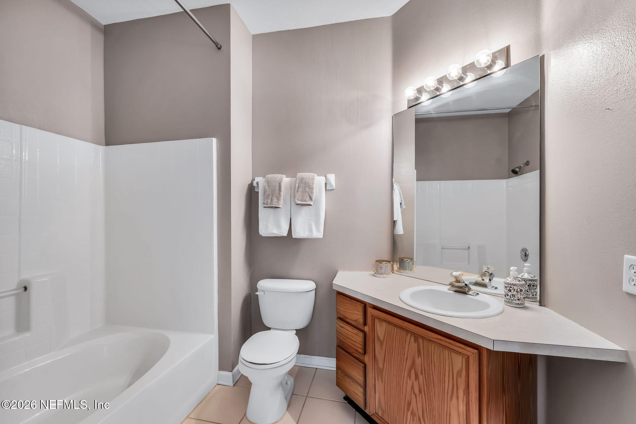 7990 Baymeadows Road East, Unit 520 Jacksonville, FL 32256 - Photo 18 of 41 a bathroom with a sink toilet a mirror and bathtub