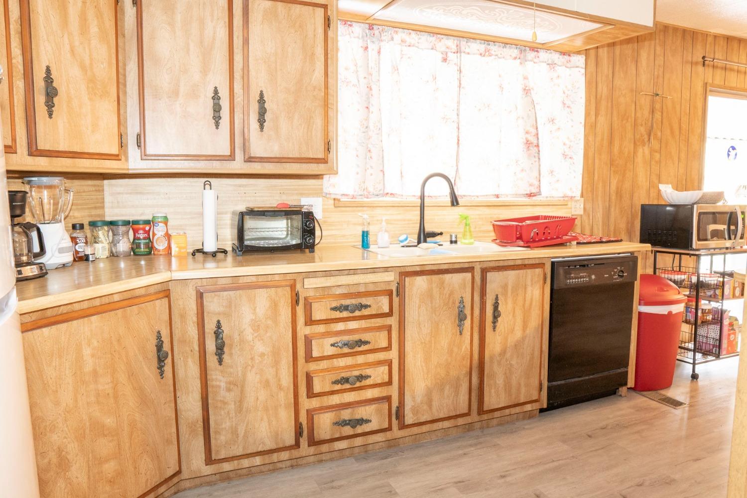 1500 Villa Avenue, Unit 117 Clovis, CA 93612 - Photo 12 of 31 a kitchen with stainless steel appliances a sink and cabinets
