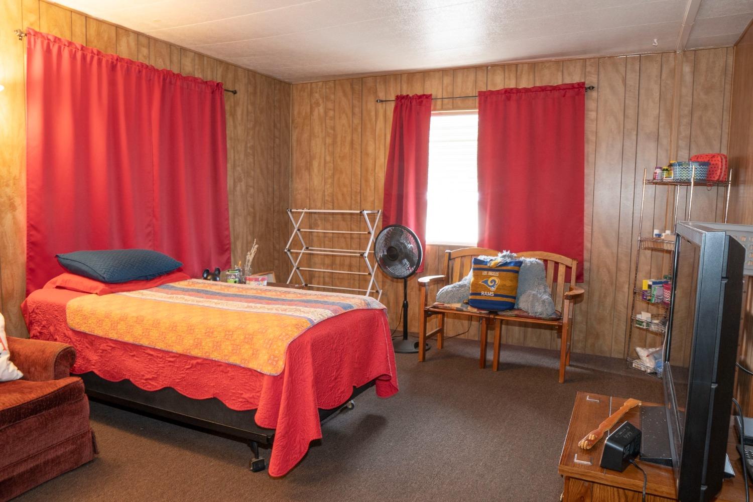 1500 Villa Avenue, Unit 117 Clovis, CA 93612 - Photo 19 of 31 a bedroom with a bed and a chair