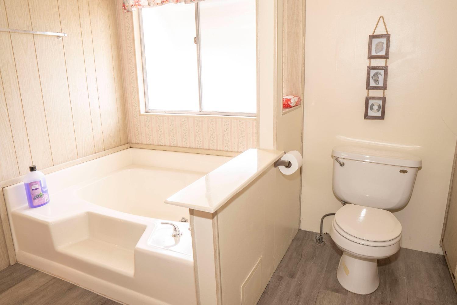 1500 Villa Avenue, Unit 117 Clovis, CA 93612 - Photo 23 of 31 a bathroom with a sink a toilet and a window