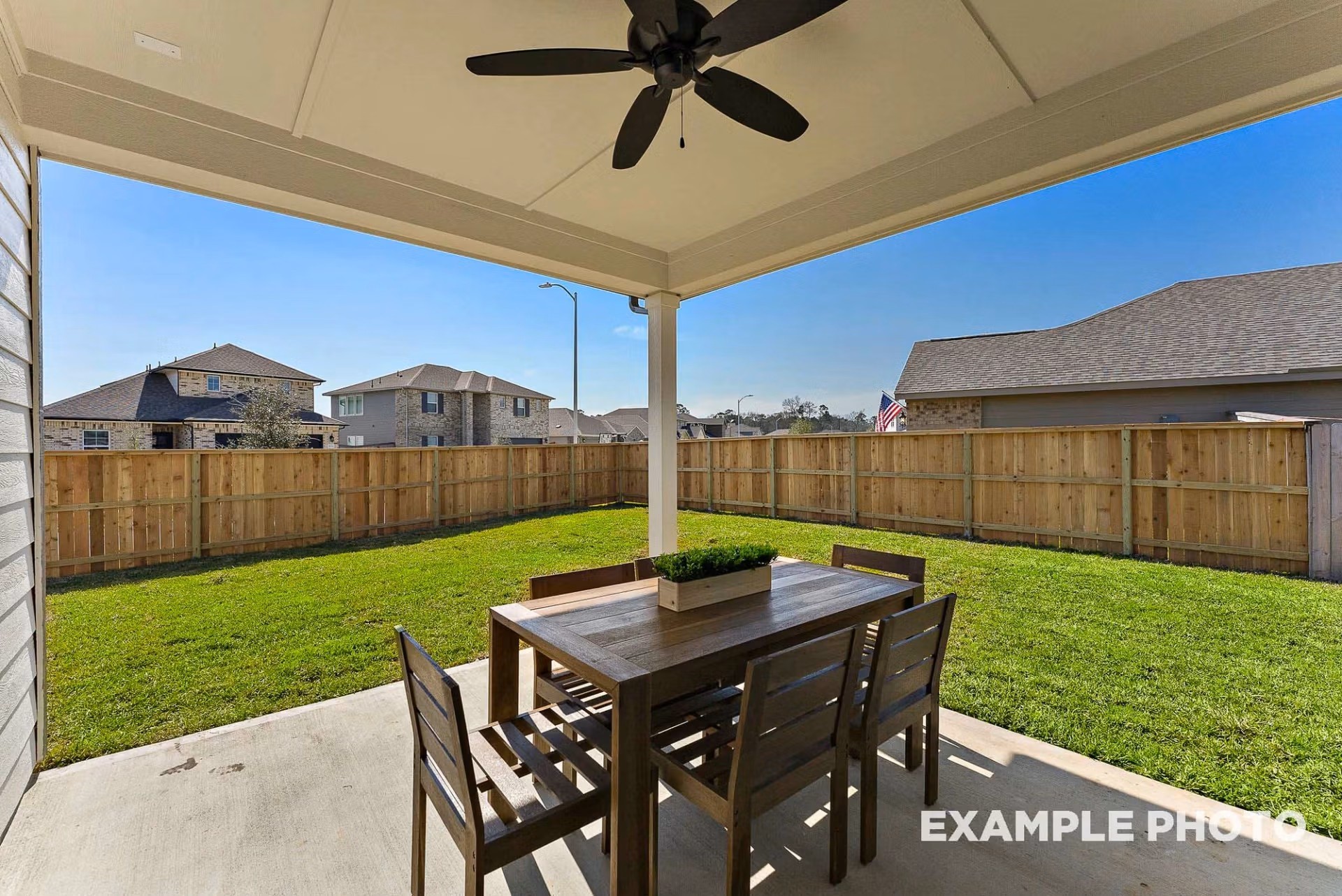 71 Leon Way Dayton, TX 77535 - Photo 22 of 25 a view of a backyard with table and chairs under an umbrella