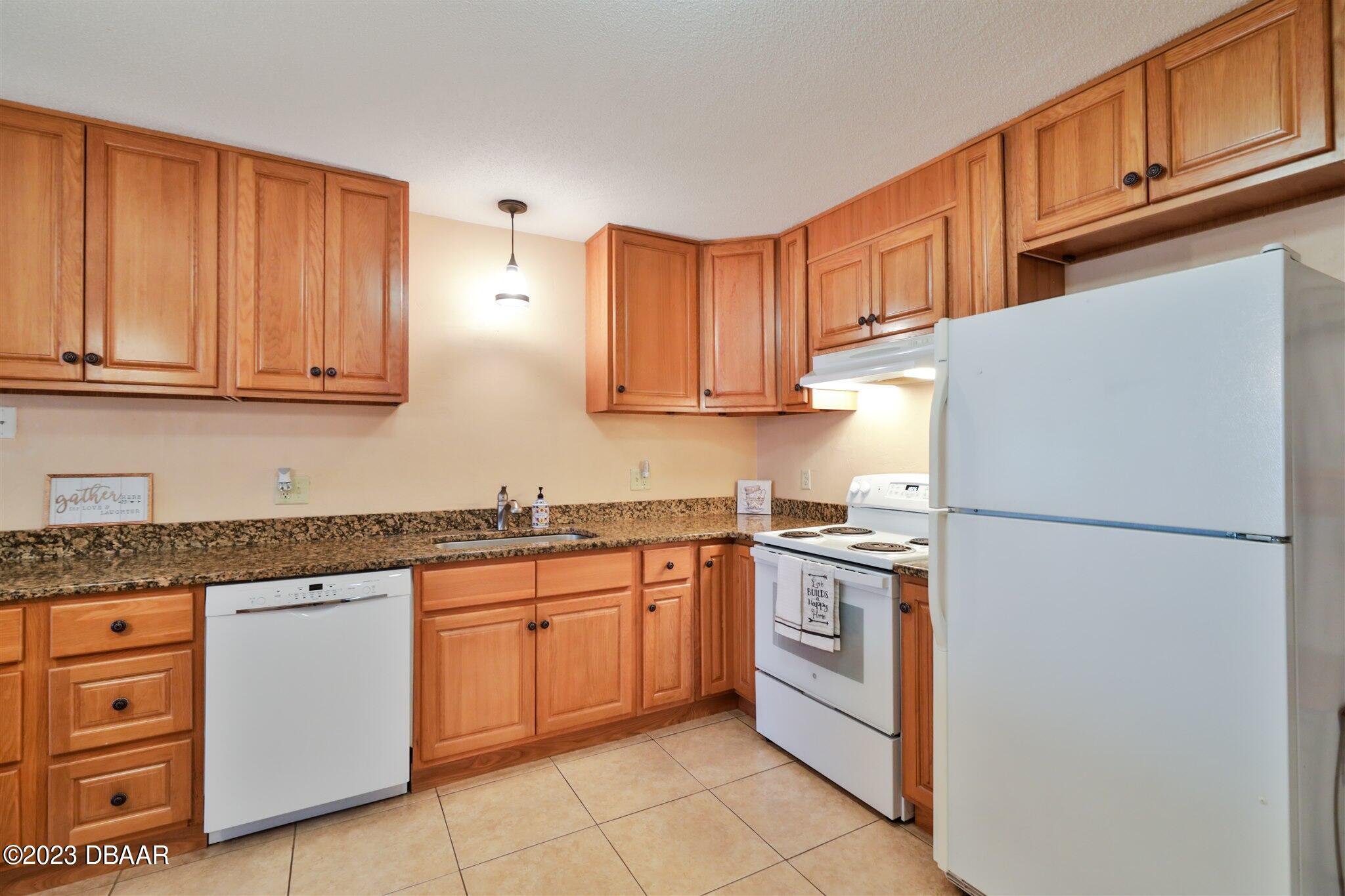 940 Northbrook Drive Ormond Beach, FL 32174 - Photo 11 of 28 a kitchen with granite countertop cabinets stainless steel appliances and a sink