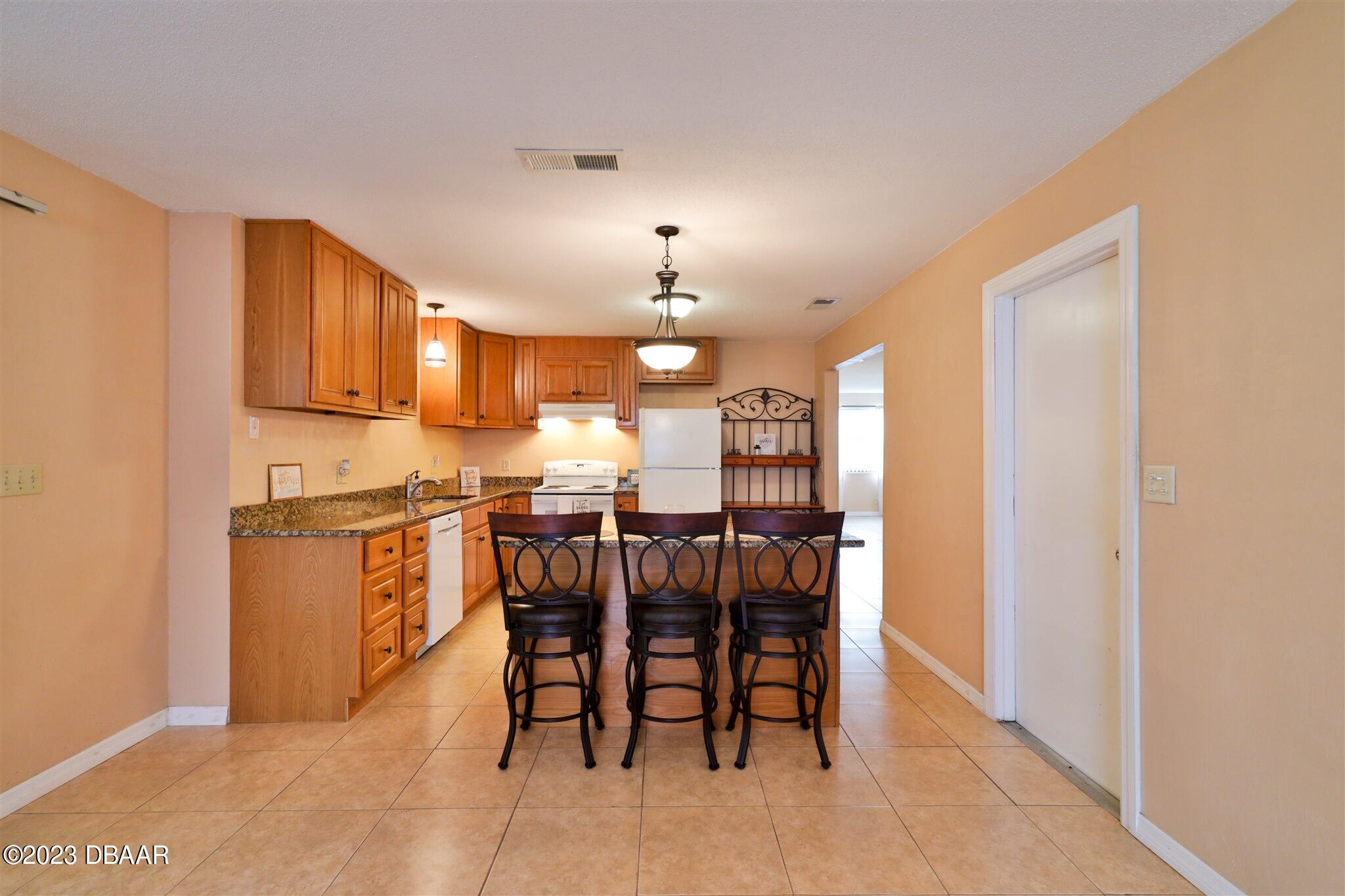 940 Northbrook Drive Ormond Beach, FL 32174 - Photo 13 of 28 a kitchen with a table and chairs in it