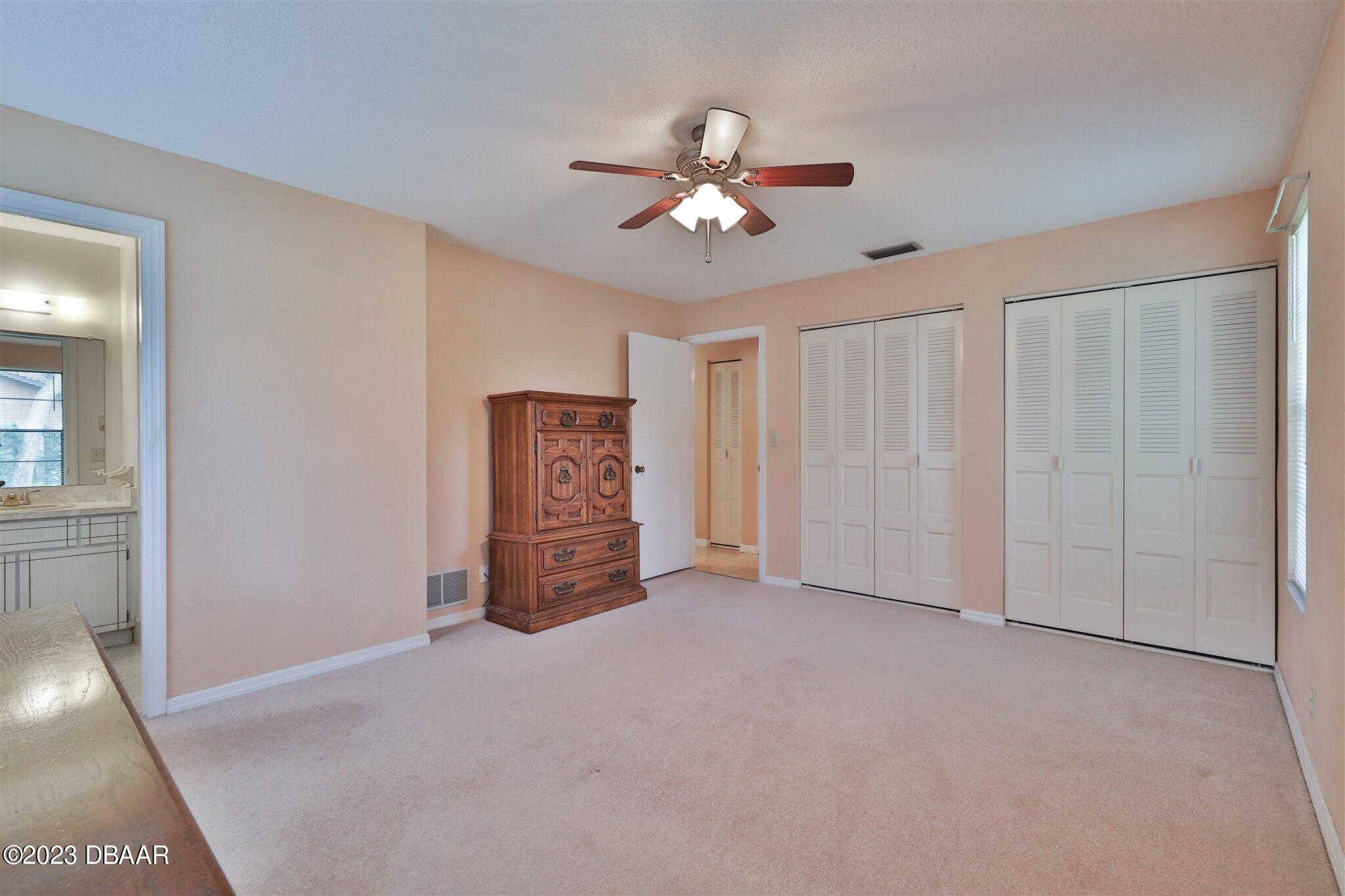940 Northbrook Drive Ormond Beach, FL 32174 - Photo 16 of 28 a view of an empty room with a ceiling fan