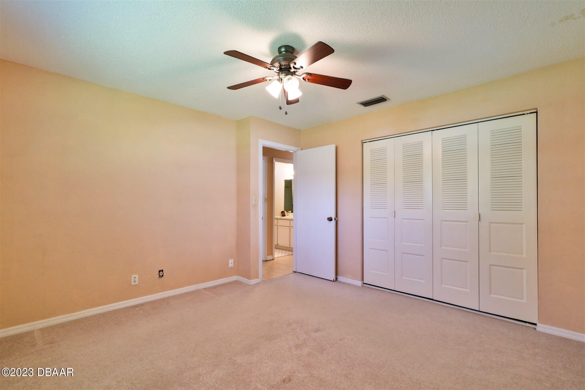 940 Northbrook Drive Ormond Beach, FL 32174 - Photo 19 of 28 a view of an empty room and a ceiling fan