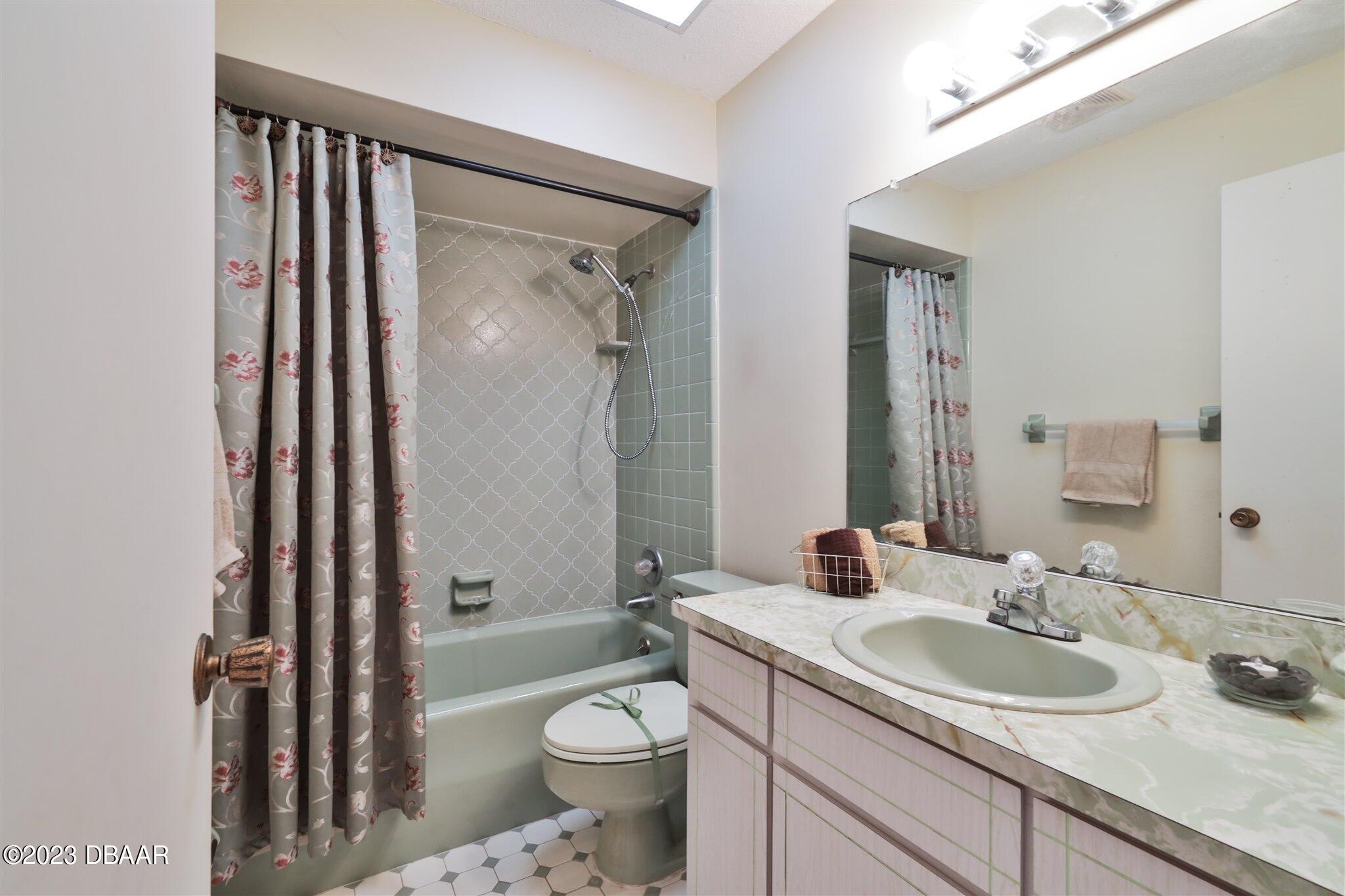 940 Northbrook Drive Ormond Beach, FL 32174 - Photo 20 of 28 a bathroom with a granite countertop sink toilet and shower