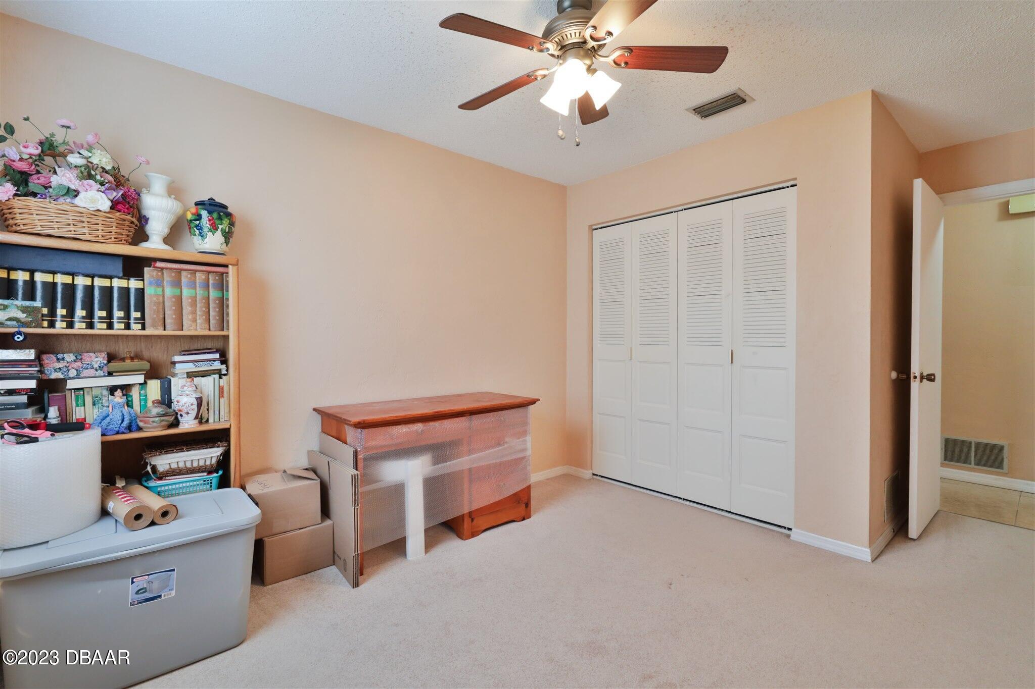 940 Northbrook Drive Ormond Beach, FL 32174 - Photo 22 of 28 a room with furniture a baby crib and a window