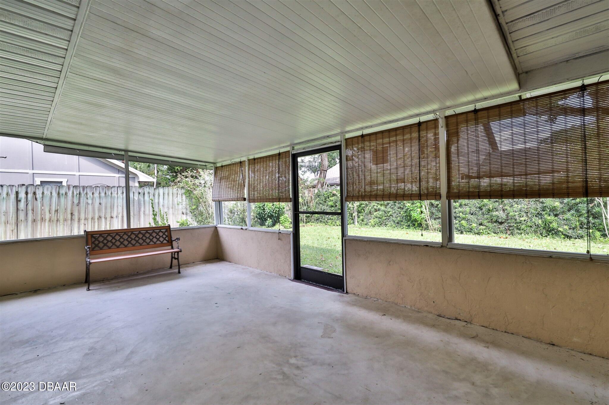 940 Northbrook Drive Ormond Beach, FL 32174 - Photo 23 of 28 a view of an empty room with furniture and a window
