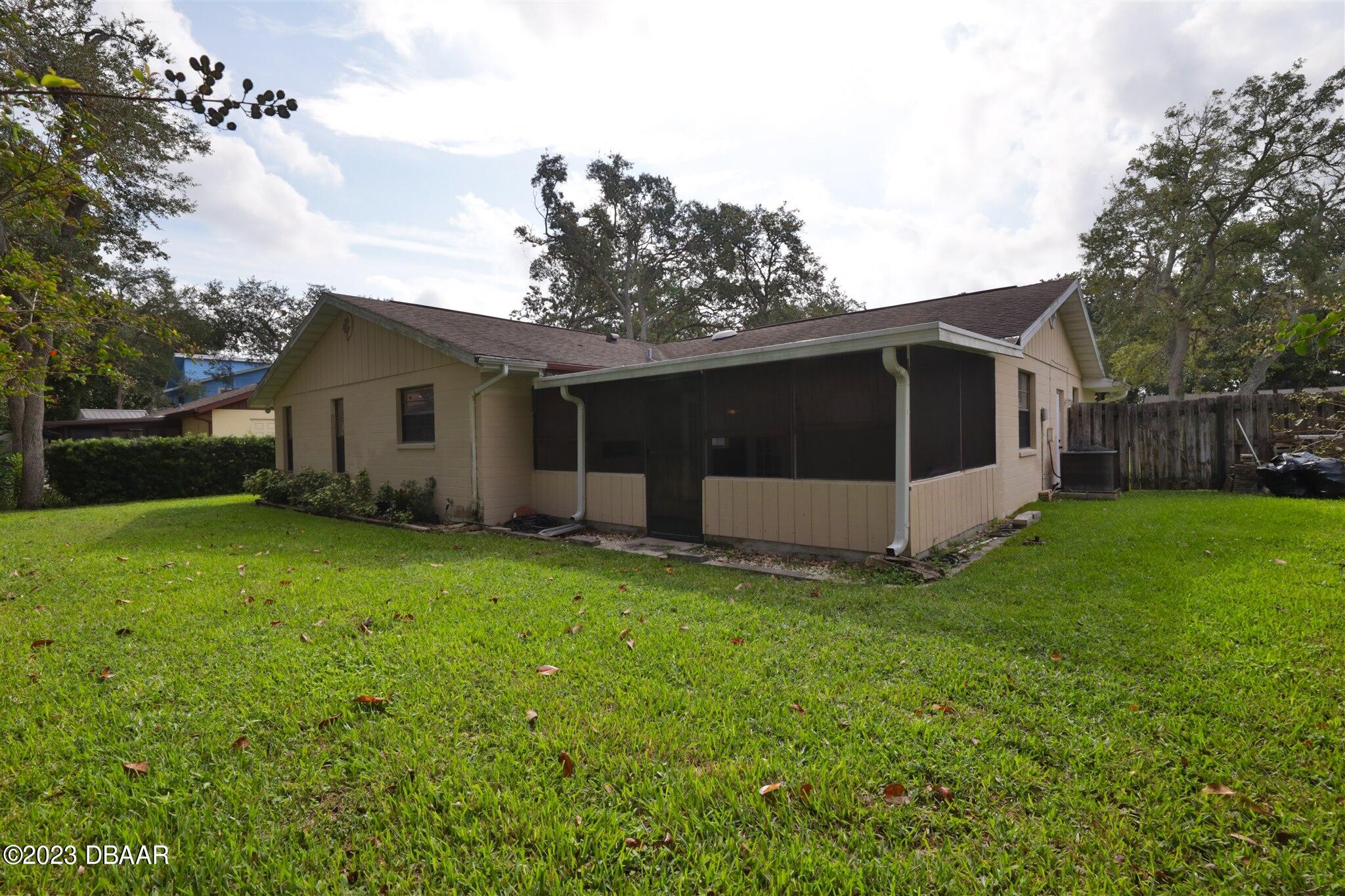 940 Northbrook Drive Ormond Beach, FL 32174 - Photo 25 of 28 a view of a house with backyard and a tree