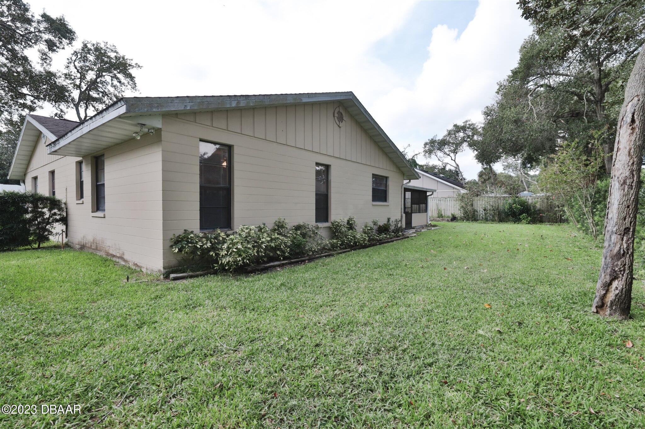 940 Northbrook Drive Ormond Beach, FL 32174 - Photo 26 of 28 a front view of house with yard and green space