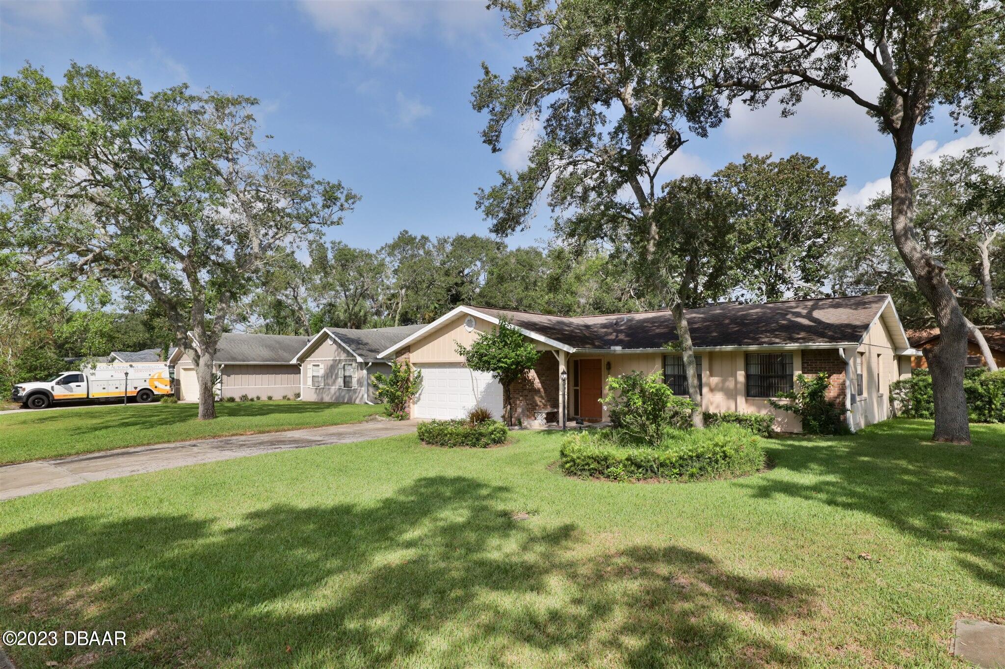 940 Northbrook Drive Ormond Beach, FL 32174 - Photo 27 of 28 a front view of a house with a yard