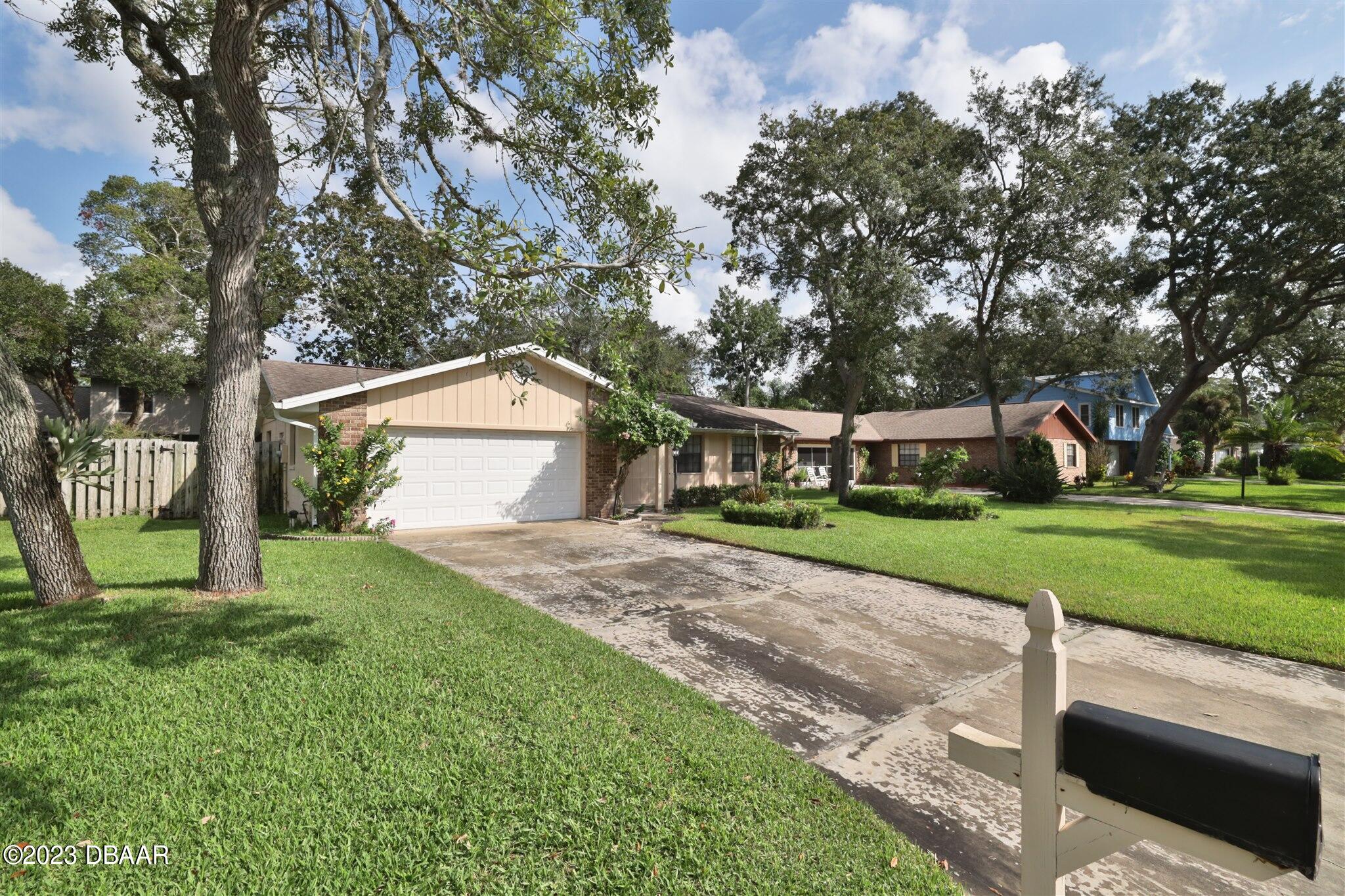 940 Northbrook Drive Ormond Beach, FL 32174 - Photo 28 of 28 a backyard of a house with plants and large tree