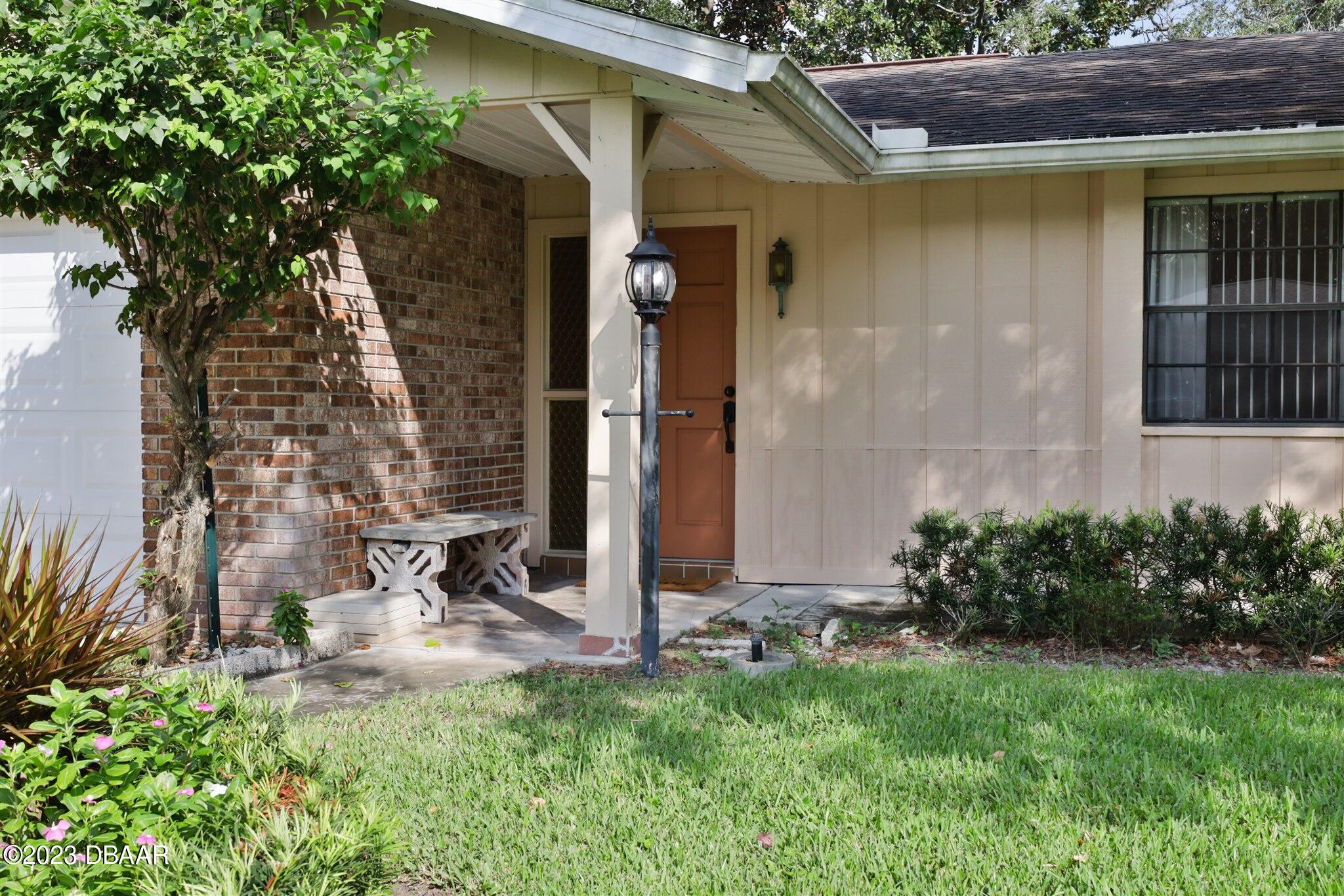 940 Northbrook Drive Ormond Beach, FL 32174 - Photo 3 of 28 a front view of a house with garden