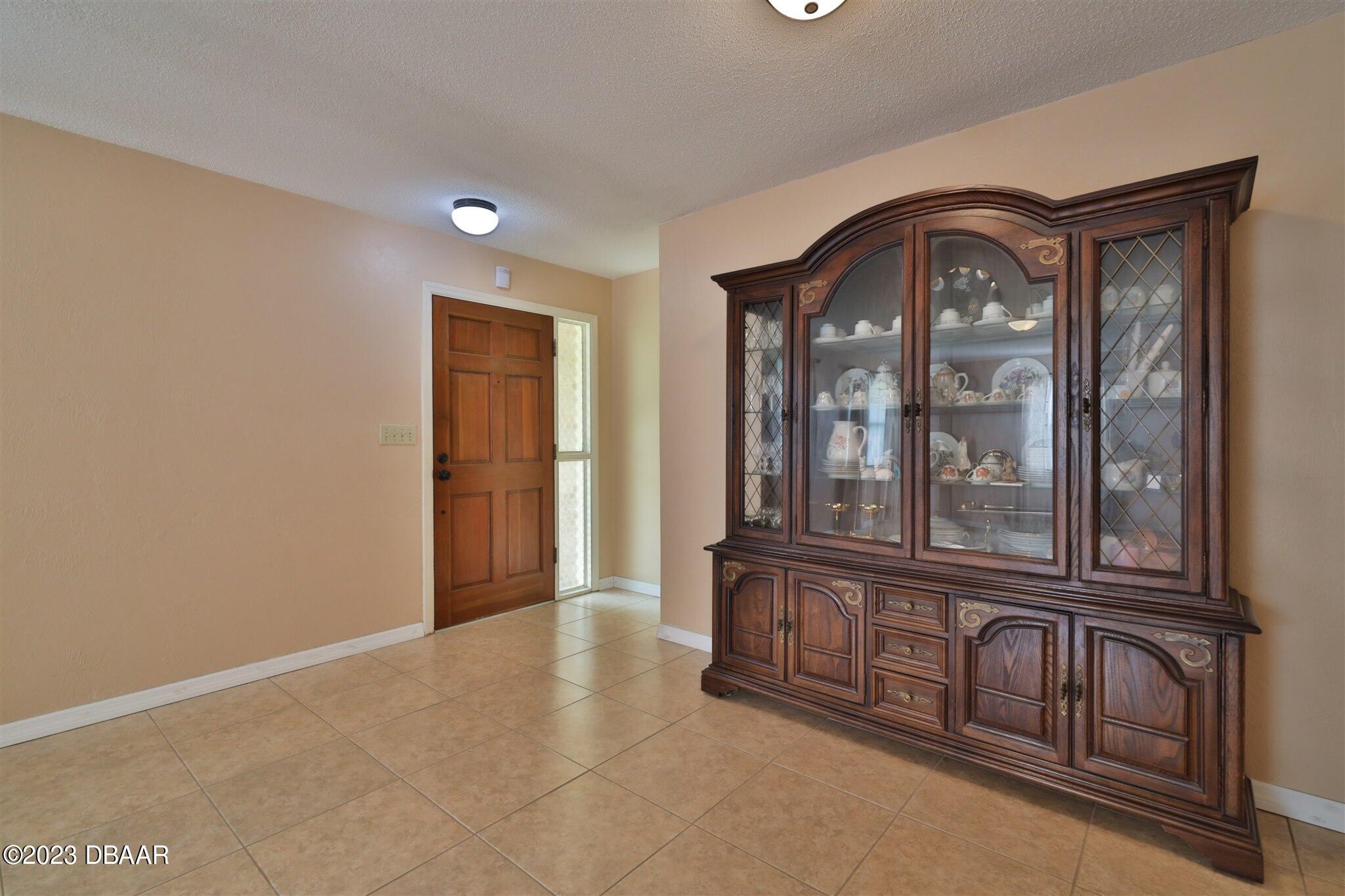 940 Northbrook Drive Ormond Beach, FL 32174 - Photo 4 of 28 an empty room with large windows