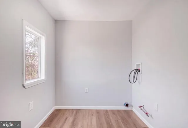a view of a room with rack on the wall and a window