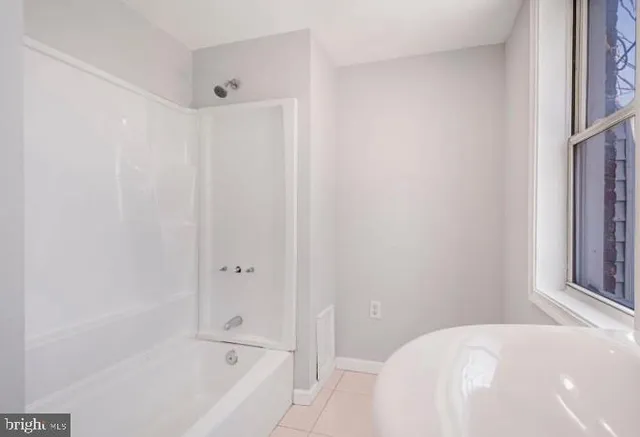 a bathroom with a bathtub and shower